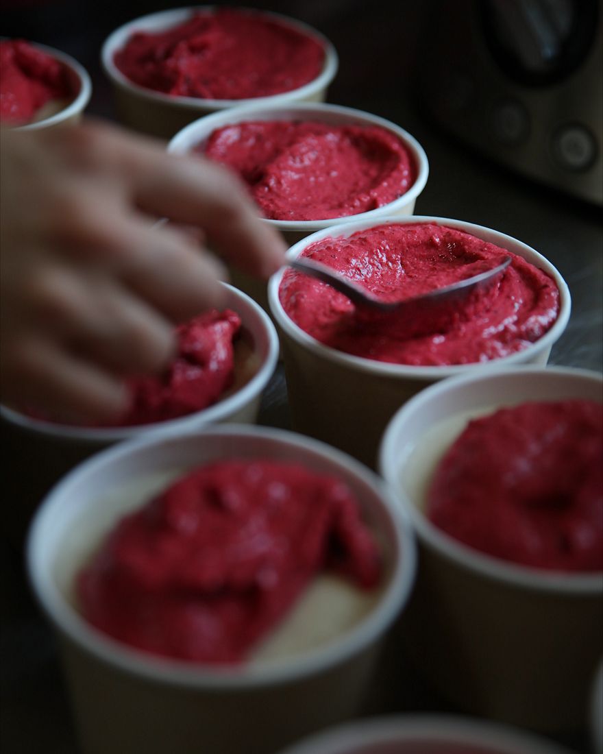 Preparing fresh berry smoothie cups