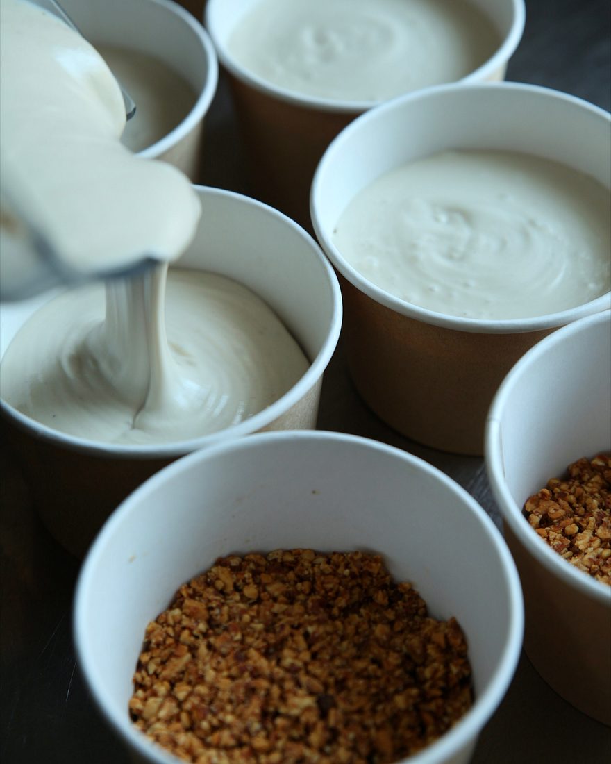 Pouring cream into granola cups